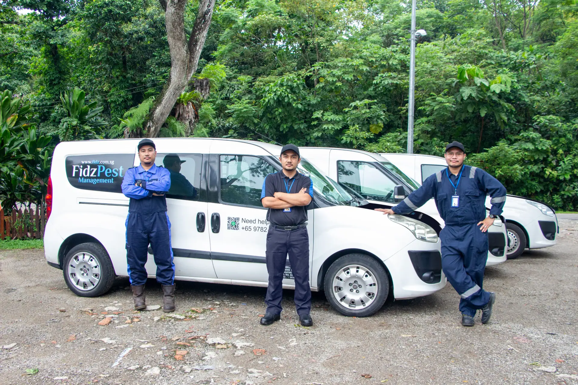 Fidz Pest Management team standing with their service vehicles